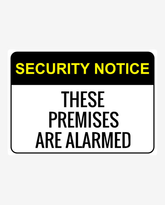 A security notice sign with black and yellow text stating 'SECURITY NOTICE THESE PREMISES ARE ALARMED'.