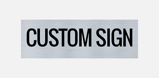 A metal printed door sign with the text 'CUSTOM SIGN' in all caps, centered on a grey background.
