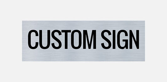 A metal printed door sign with the text 'CUSTOM SIGN' in all caps, centered on a grey background.