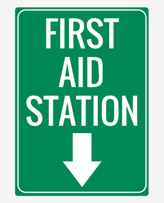 A green sign with white text stating 'FIRST AID STATION' with a white arrow pointing down.