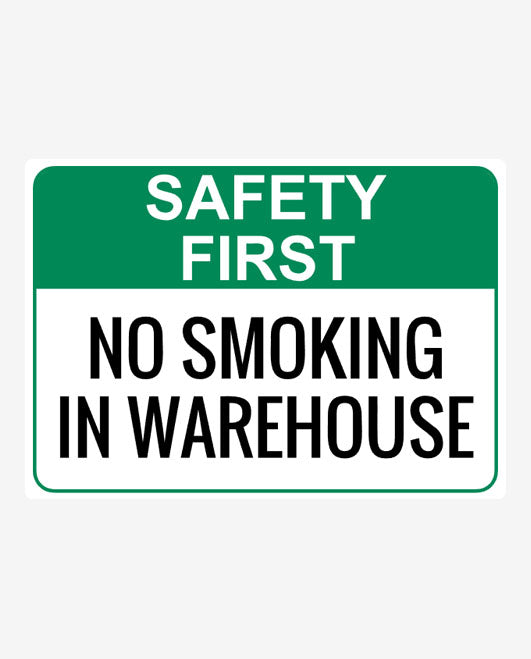 A sign with a green and white background displaying the text 'SAFETY FIRST NO SMOKING IN WAREHOUSE'.