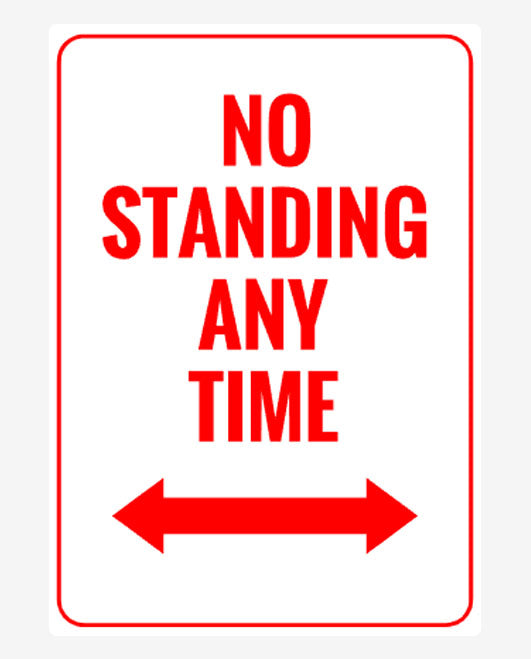 A rectangular parking sign with a white background and red text that reads 'NO STANDING ANY TIME' with a two side red arrow.
