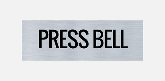 A metal sign with the words 'PRESS BELL' printed in capital letters.