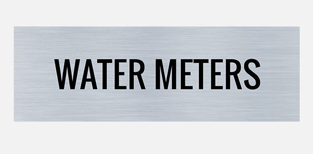 A rectangular metal sign with the words 'WATER METERS' printed in capital letters.