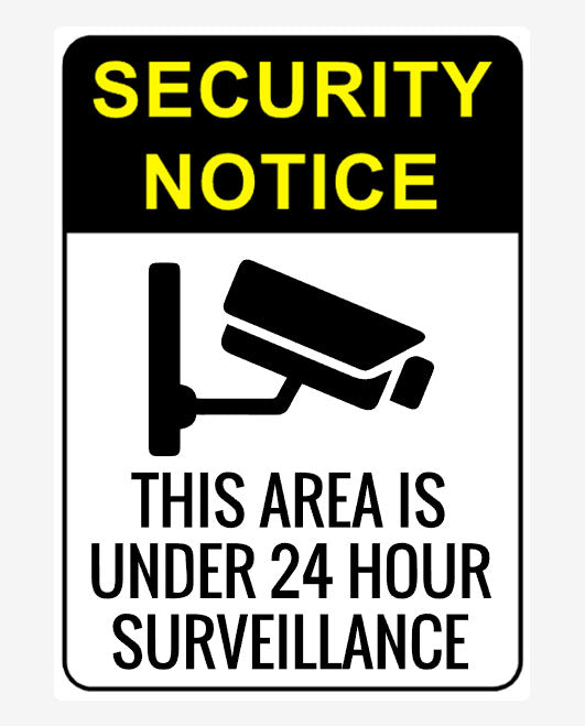 A security sign with a camera icon and text stating 'SECURITY NOTICE THIS AREA IS UNDER 24 HOUR SURVEILLANCE'.